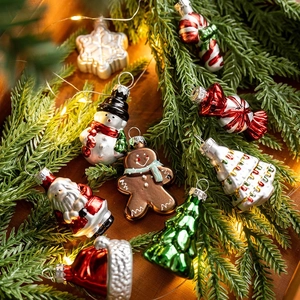 Festive Christmas glass ornaments set with Santa and Snowman on green pine branches