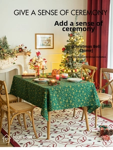 Detail of dark green Christmas tablecloth with gold snowflake and pine tree patterns