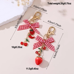 Detailed view of red plaid bow fruit pendants with metal clasp and size specifications