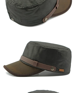Detailed macro view of dark grey army cap with brown brim and metal decorative buckle