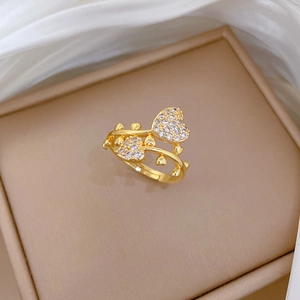 Close-up of golden adjustable heart ring with sparkling zircons in a luxury display box