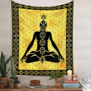 Detail of bohemian meditation tapestry with chakra symbols on a yellow wall with home decor