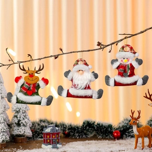 Christmas plush ornaments featuring Santa, Reindeer, and Snowman hanging on rustic branches
