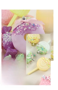 Detail of candy-shaped Christmas ornaments including donuts and lollipops with glitter