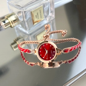 Elegant rose gold quartz watch with red enamel bracelet and rhinestone indices