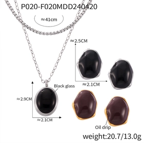 Detailed view of vintage jewelry set featuring oval glass pendants and earring dimensions