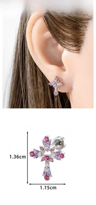 Detailed view of hollow heart cross earring with micro-set pink and purple zircons