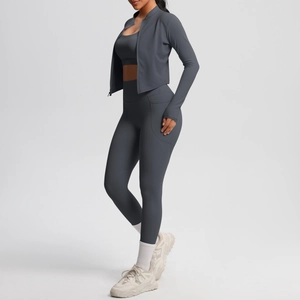 Detail of dark gray sports set featuring side pockets on leggings and thumbhole sleeves