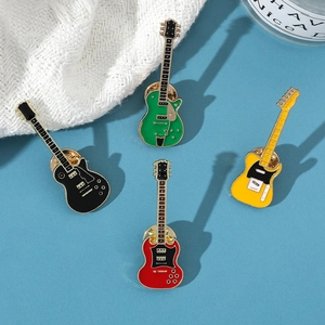 Macro detail of four colorful vintage electric guitar enamel pins with golden metal edges