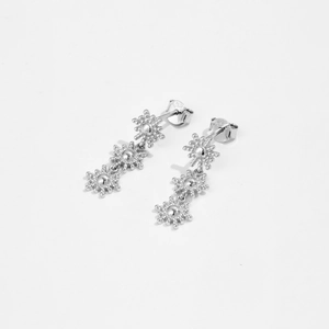 Detail view of S925 sterling silver long drop earrings with triple starburst floral motifs
