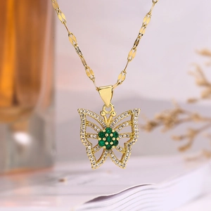Gold butterfly necklace with green gemstone and white zircons, elegant dainty jewelry