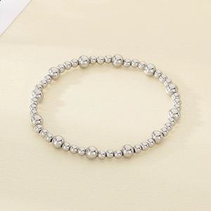 Macro shot of polished stainless steel beads in graduated sizes on a stylish bracelet