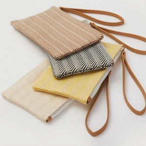 Handwoven straw clutch bags set in four colors with leather wristlets and zippers