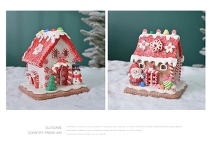 Detailed view of handmade light-up Christmas gingerbread houses with snowman and Santa decor