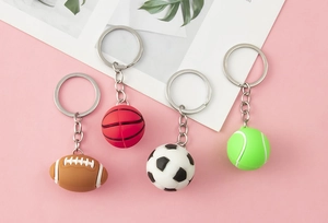 Detailed view of 3D sports ball keychains including soccer, basketball, rugby, and tennis