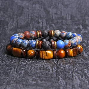 Macro shot of natural tiger eye and lava stone beads on double-layered men's bracelets