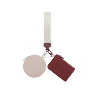 Close-up of portable wristlet pouch set with round and rectangular zipper coin bags