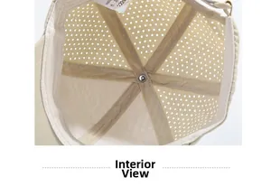 Interior detail of a beige summer mesh baseball cap showing breathable holes and stitching