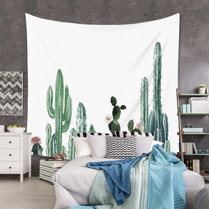 Detail of bohemian cactus tapestry hanging as bedroom headboard backdrop decoration