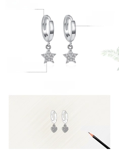 Macro detail of S925 sterling silver hoop earrings with star and heart zircon charms