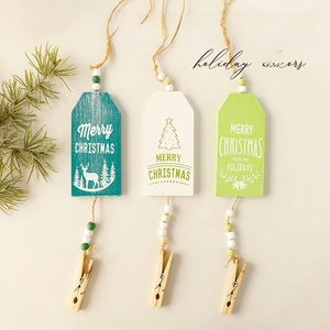 Three colorful Christmas wooden ornaments with hanging strings and small clips for tree decor