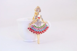 Close-up of ballet dancer keychain with vibrant colorful rhinestones on a gold frame