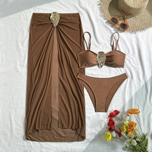 Detailed flat lay of a brown 3-piece bikini set with golden shell-shaped metal buckles