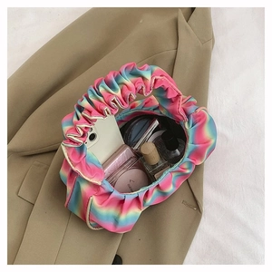 Top view of rainbow gradient pleated cloud bag showing spacious interior compartment