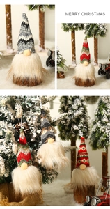 Close-up of lighted Christmas gnomes with knitted hats on a festive tree display