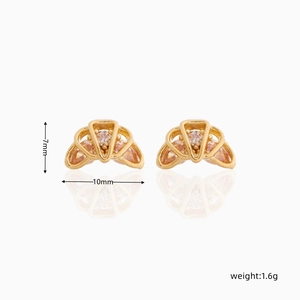 Macro shot of 18K gold plated croissant stud earrings with sparkling zircon stones