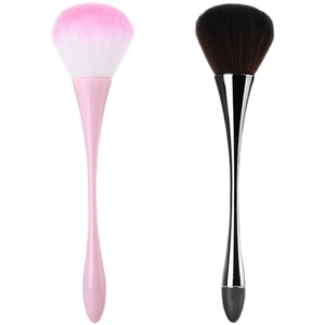 Detail view of pink and black makeup brushes with fluffy heads and sleek long handles
