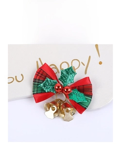 Detail of Christmas plaid bow with holly leaves, red beads, and golden bells decoration