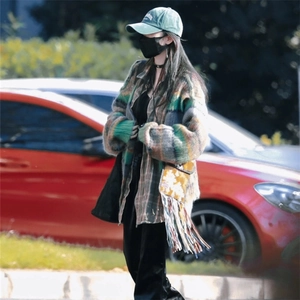 Vintage green washed baseball cap with embroidery, styled with a colorful knit cardigan