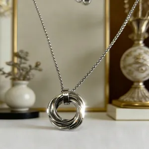 Minimalist silver-toned triple ring pendant necklace in stainless steel with crystal
