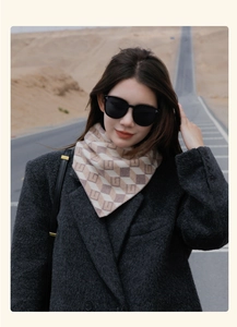Outdoor portrait of a model wearing a soft beige and white checkered scarf and sunglasses