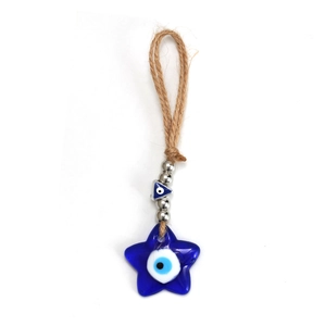Macro detail of Evil Eye star ornament made of royal blue glass and natural hemp rope