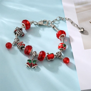 Christmas charm bracelet with red glass beads, bells, and snowman on a silver snake chain