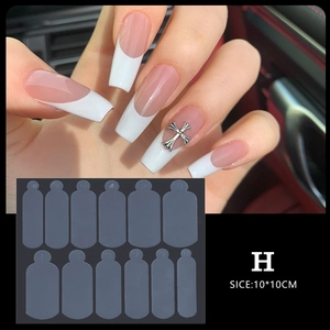 Dual view of French nail tips with silver cross decor and numbered clear acrylic molds