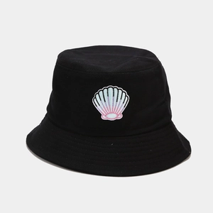 Close-up of a gradient shell embroidery on a black cotton sun bucket hat fabric