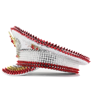 Detail of white captain hat with silver sequins, white pearls and colorful metal spikes