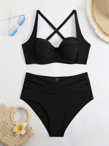 Detail of high waist bikini bottom with cross-over ruched design and black top
