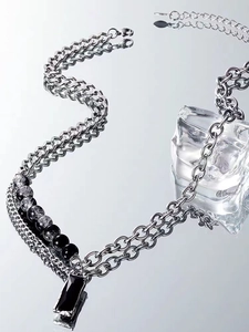 Detail of double-layer titanium necklace with black rectangle pendant and silver chain