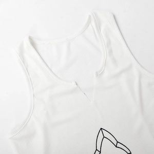 Macro detail of white ribbed knit dress featuring a V-neckline and premium texture