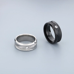 Polished stainless steel feather rings with cubic zirconia in black and silver finishes