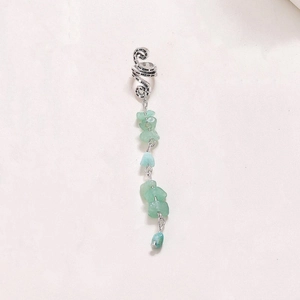Detail view of silver textured ear cuff with hanging green natural stone pendant chains