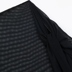 Close-up of black sheer mesh fabric with fine texture and neat hem stitching detail