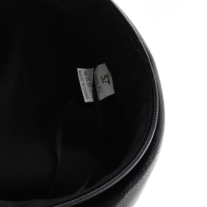 Detail view of the 100% PU leather lining and size 57 care label inside the captain hat