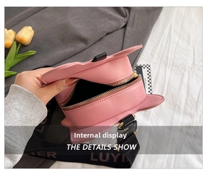 Detail view of pink cat-ear violin bag with metal zipper and printed wide strap