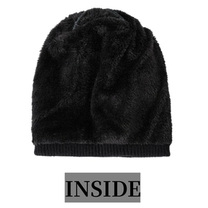 Detail of winter beanie's interior with thick faux fur lining and soft black thermal texture