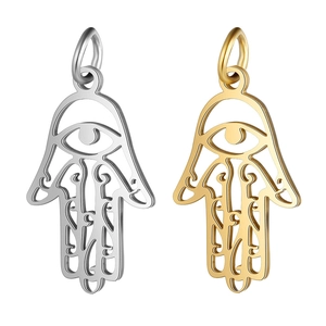 Detailed view of silver and gold Hamsa Hand pendants with hollow-out metal design